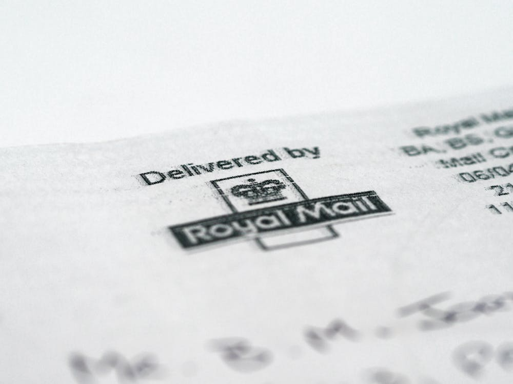 Black and white printer paper with Royal Mail logo in close up shot.